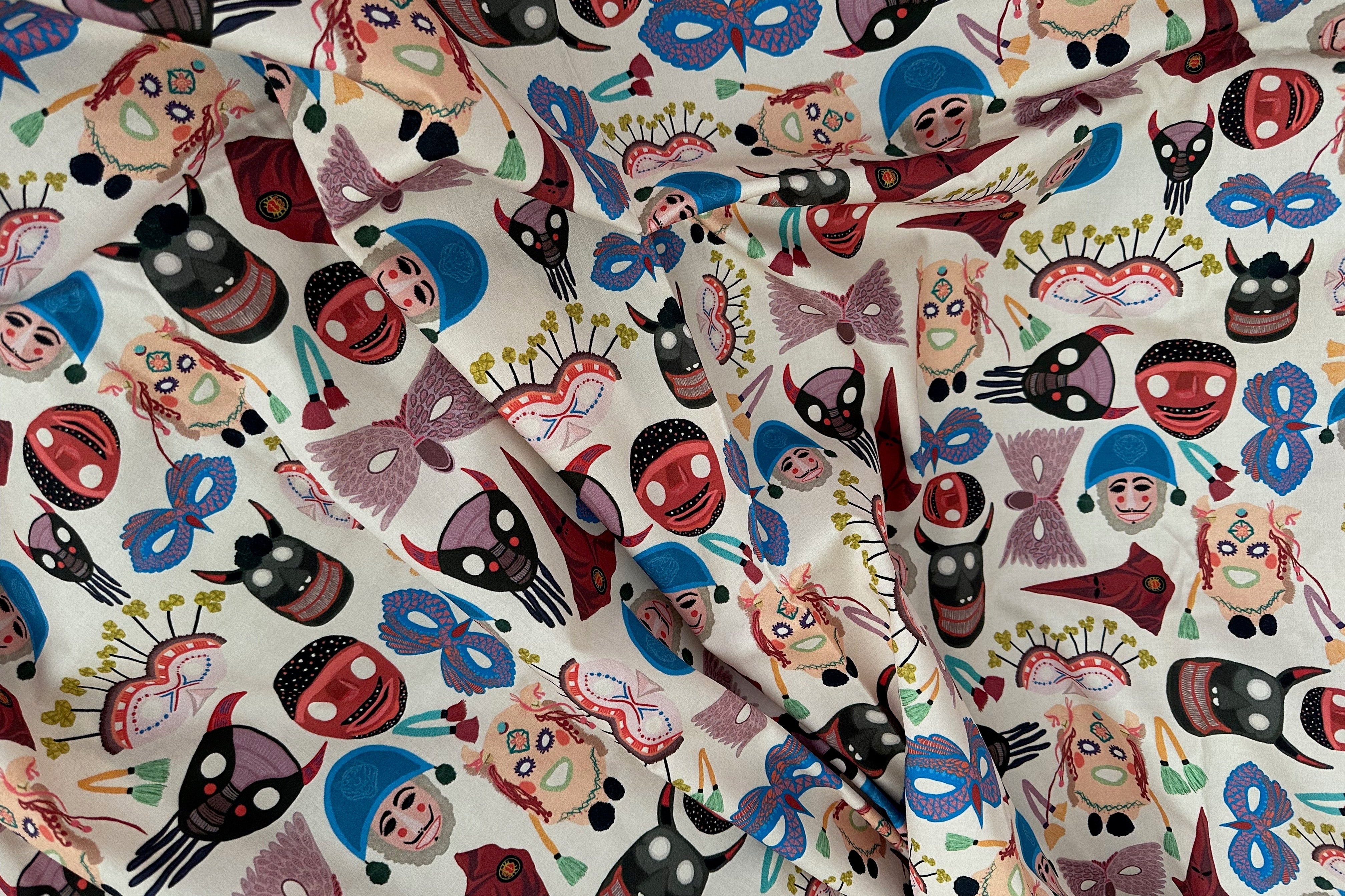 Patterned fabric with colorful masks and bows on a white background